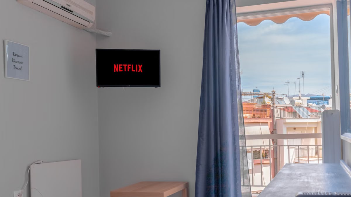 Cozy living room with a view, featuring a TV and balcony access.